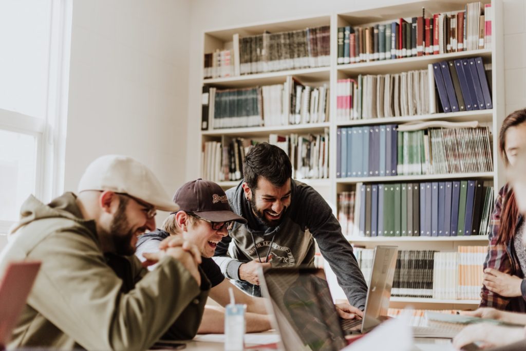 a group of people looking at a book